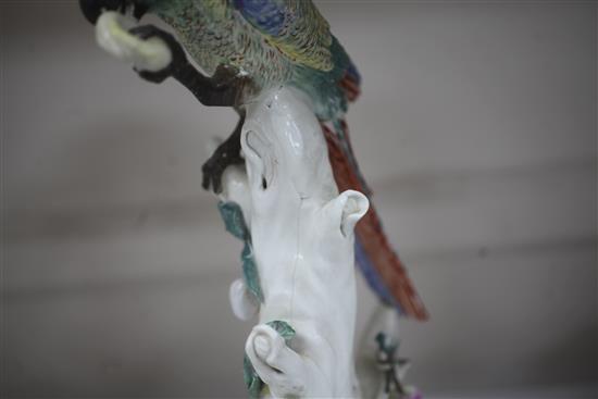 A rare pair of Naples Real Fabbrica porcelain figures of parrots on fruiting branches, early 19th century, height 26.5cm and 27cm, exte